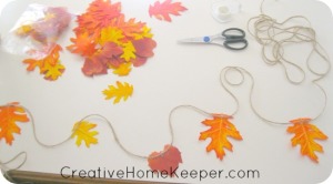 Add a little warmth and a touch of fall to your home with this simple DIY twine and leaf garland. Only a few supplies needed, this makes for an easy and frugal family friendly fall craft. | CreativeHomeKeeper.com